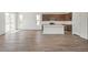 Bright, open-concept living space featuring stylish flooring and a modern kitchen with an island at 13392 E 110Th Way, Commerce City, CO 80022