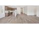 Bright, open-concept living space featuring stylish flooring and a modern kitchen with an island at 13392 E 110Th Way, Commerce City, CO 80022