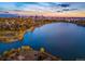 Breathtaking aerial view of a serene lake and the city skyline during a beautiful sunset at 3520 W Conejos Pl # 14, Denver, CO 80204