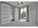 Bright bedroom with modern closet doors and access to a private balcony at 3520 W Conejos Pl # 14, Denver, CO 80204