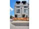 Modern townhome exterior showcases clean lines, multiple large windows, and a wood privacy fence in front at 3520 W Conejos Pl # 14, Denver, CO 80204