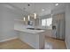 Modern kitchen featuring stainless steel appliances, quartz countertops, and light wood cabinetry at 3520 W Conejos Pl # 14, Denver, CO 80204