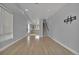 Bright living room with hardwood floors, staircase, and open view to the kitchen at 3520 W Conejos Pl # 14, Denver, CO 80204