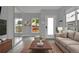 Modern living room featuring neutral color palettes, sleek furniture, and abundant natural light from large windows at 3520 W Conejos Pl # 14, Denver, CO 80204