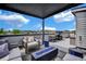 Inviting rooftop deck with modern furniture, grill, fire pit, and city views in a luxury townhome at 3520 W Conejos Pl # 14, Denver, CO 80204