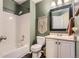 Traditional bathroom showcasing a shower-tub combo, a white vanity, and neutral-toned accents at 9694 Canberra Dr, Highlands Ranch, CO 80130