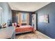 Cozy bedroom featuring a metal-framed bed, warm-toned bedding, and an eclectic mix of decor at 9694 Canberra Dr, Highlands Ranch, CO 80130