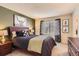 Relaxing bedroom features a queen-size bed, neutral decor, and plenty of natural light at 9694 Canberra Dr, Highlands Ranch, CO 80130