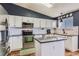 Bright kitchen featuring white cabinets, stainless steel appliances, and ample counter space for cooking at 9694 Canberra Dr, Highlands Ranch, CO 80130
