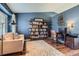 Inviting home office space with custom shelving, a comfy couch, and a stylish desk setup at 9694 Canberra Dr, Highlands Ranch, CO 80130