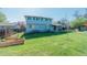 Spacious backyard showcases a vibrant lawn, raised garden beds, and the home's exterior at 6621 S Cherry Way, Centennial, CO 80121