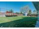 Expansive backyard featuring a well-maintained lawn, shed, and shade sail, perfect for outdoor activities at 6621 S Cherry Way, Centennial, CO 80121