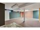 The finished basement offers an open layout with neutral carpet and color blocked walls at 6621 S Cherry Way, Centennial, CO 80121