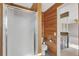 Bathroom features wood walls, a shower, and views into the main bedroom at 6621 S Cherry Way, Centennial, CO 80121