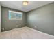 Neutral bedroom features a window that provides natural light and neutral carpeting at 6621 S Cherry Way, Centennial, CO 80121