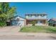 Attractive two-story house with an attached garage, brick facade, and established landscaping at 6621 S Cherry Way, Centennial, CO 80121