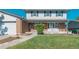 Close-up of a well-maintained front yard with a charming walkway leading to the front door at 6621 S Cherry Way, Centennial, CO 80121