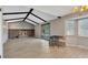 Open living space with fireplace, wood beams, and sliding glass door to the backyard at 6621 S Cherry Way, Centennial, CO 80121