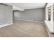 Bright living room featuring modern gray walls, elegant wood-look floors, and ample natural light at 6621 S Cherry Way, Centennial, CO 80121