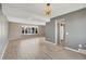 Open-concept living area featuring wood-look floors, neutral walls, and an abundance of natural light at 6621 S Cherry Way, Centennial, CO 80121
