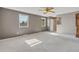 Spacious main bedroom with large windows, a ceiling fan, and an ensuite bathroom at 6621 S Cherry Way, Centennial, CO 80121