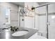 Bright bathroom featuring a vanity with a gray countertop and chrome fixtures and tiled walk-in shower at 14833 E Crestridge Dr, Centennial, CO 80015