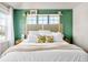 Inviting bedroom showcasing a decorative headboard, bright green accent wall and great natural light at 14833 E Crestridge Dr, Centennial, CO 80015