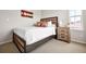 Comfortable bedroom with rustic wood furnishings including bed, nightstand, and a window letting in natural light at 14833 E Crestridge Dr, Centennial, CO 80015