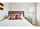 Cozy bedroom showcasing a bed with accent pillows, a rustic headboard, and a bedside table with a lamp at 14833 E Crestridge Dr, Centennial, CO 80015