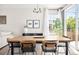 Open dining room featuring hardwood floors, stylish lighting, and access to outdoor space at 14833 E Crestridge Dr, Centennial, CO 80015