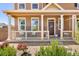 Inviting front porch with classic columns and ample seating space at 14833 E Crestridge Dr, Centennial, CO 80015