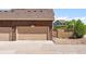 Garage with two-car garage doors, a brick exterior, and an attached gate at 14833 E Crestridge Dr, Centennial, CO 80015
