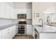 Well-lit kitchen featuring white cabinets, stainless steel appliances, and granite countertops at 14833 E Crestridge Dr, Centennial, CO 80015