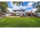 Beautifully landscaped backyard with a spacious lawn, patio area, and mature trees at 10130 E Powers Ave, Greenwood Village, CO 80111