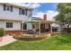 Charming backyard with lush green lawn, a brick patio, and a well-maintained garden, perfect for outdoor living at 10130 E Powers Ave, Greenwood Village, CO 80111