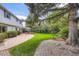 Expansive backyard featuring a well-maintained lawn, patio, mature trees, and tasteful landscaping at 10130 E Powers Ave, Greenwood Village, CO 80111