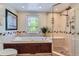 Luxurious bathroom with a soaking tub, shower, and decorative stained glass window at 10130 E Powers Ave, Greenwood Village, CO 80111