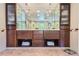 Stylish bathroom with double vanity, custom cabinetry, and tile flooring at 10130 E Powers Ave, Greenwood Village, CO 80111