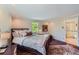 Comfortable bedroom with ensuite bathroom access and a bright window view at 10130 E Powers Ave, Greenwood Village, CO 80111