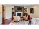 Comfortable bedroom with sitting area, fireplace, and ensuite bathroom access at 10130 E Powers Ave, Greenwood Village, CO 80111