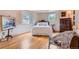 Cozy bedroom with hardwood floors, two windows, and a lovely bed, perfect for relaxation and rest at 10130 E Powers Ave, Greenwood Village, CO 80111