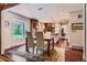 Open concept dining room with hardwood floors, view to the kitchen and natural light at 10130 E Powers Ave, Greenwood Village, CO 80111