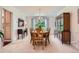Elegant dining room with classic furnishings, chandelier, and a large window at 10130 E Powers Ave, Greenwood Village, CO 80111
