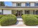 Inviting front entrance of a home, featuring a stylish door, decorative plants, and manicured bushes at 10130 E Powers Ave, Greenwood Village, CO 80111