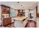 Spacious kitchen with custom cabinets, granite countertops, and a large center island at 10130 E Powers Ave, Greenwood Village, CO 80111