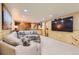 Open-concept living room with recessed lighting, a bar area, and a large sectional sofa for comfort at 10130 E Powers Ave, Greenwood Village, CO 80111