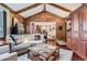 Inviting living room featuring wood paneling, vaulted ceilings, and an open layout at 10130 E Powers Ave, Greenwood Village, CO 80111