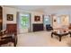 Bright living room with large windows, classic furnishings, and neutral carpet at 10130 E Powers Ave, Greenwood Village, CO 80111