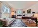 Inviting home office with hardwood floors, a refined desk, and a comfortable daybed for a flexible workspace at 10130 E Powers Ave, Greenwood Village, CO 80111