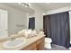 Full bathroom boasts a shower, tub, and bright vanity at 13271 Holly St # B, Thornton, CO 80241